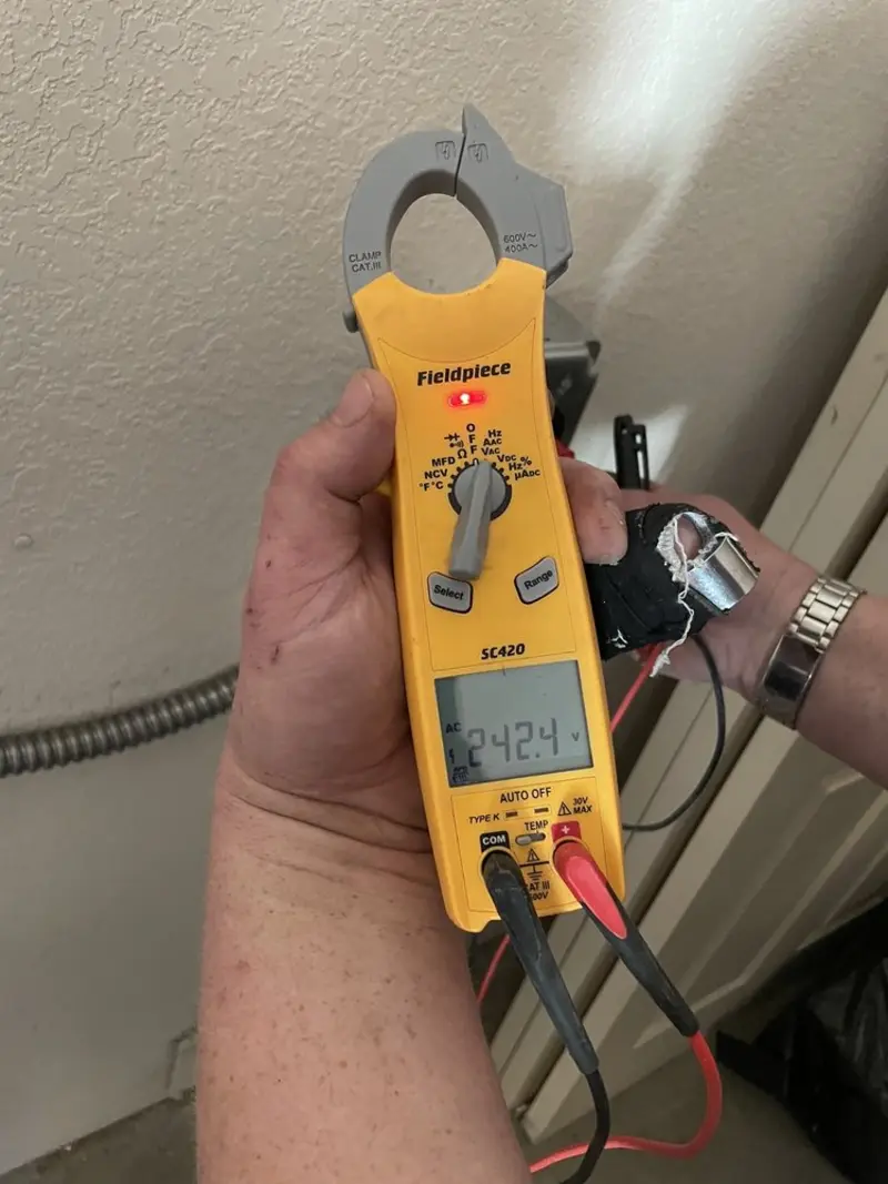 Voltage testing with clamp meter during Recessed Lighting Installation in Crowley